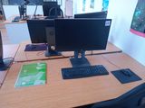 a computer desk with two monitors and a keyboard