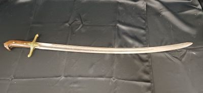 un gros plan d'une épée posée sur un tissu noir, sur une table