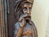 a wooden statue of a man with a turban on his head