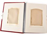 an open book with a picture in it on a white surface