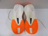 pair of orange and white tennis shoes on a white surface