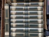 several books stacked on top of each other in a cardboard box