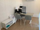 a desk with two chairs and a computer on top of it