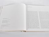 an open book sitting on top of a white table