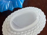 two blue and white dishes sitting on a wooden table