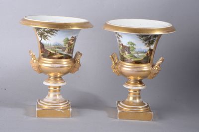 pair of gold and white vases with a painting on them
