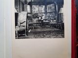 an open book with a black and white photo of a living room