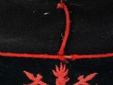 a black hat with a red design on it