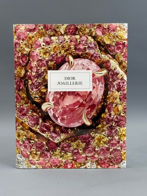 a book with a pink cover and gold foil on it