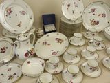 many different types of plates and bowls on the table