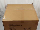 cardboard box sitting on a white surface with a white curtain behind it