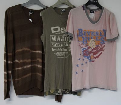 three shirts hanging on a hanger on a wall