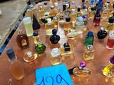 many bottles of perfume sitting on a table with a price tag