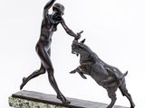 bronze statue of a woman and a bull fighting