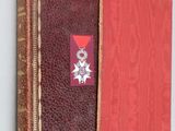 an old book with a red cover and a star on the cover