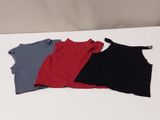 a group of three shirts sitting on top of a white table