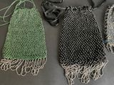 three purses are lined up on a black table