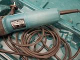 a corded drill in a box with a cord in it