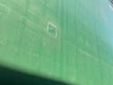 a large green building with a clock on the side of it