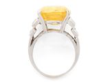 a close up of a ring with a yellow stone in it