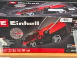 an image of a toy lawn mower in a box on a table