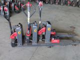 a lot of red and black forklifts in a warehouse