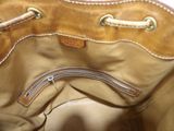 a tan purse with a zipper on the inside of it