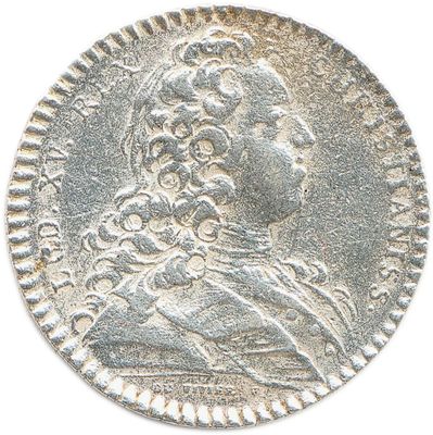 a close up of a silver coin with a woman on it