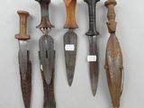 several different types of knives are displayed on a white surface