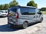 a silver van that is parked in a parking lot