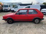 an image of a red car parked in a lot with other cars