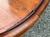 a close up of a wooden table with a crack in the top