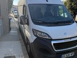 the white van is parked on the side of the street