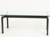 une table en verre avec des pieds noirs et un plateau en verre