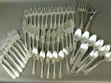 a lot of silver spoons and forks on the table