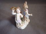 a figurine of a boy and a girl on a rock