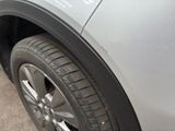 a close up of a car ' s tire on the side of the road