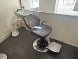 an image of a hair salon chair in the corner of a room