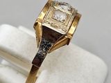 an image of a gold ring with a diamond in it