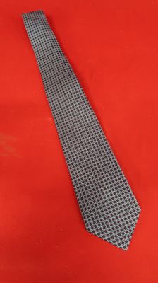 a close up of a tie on a red surface