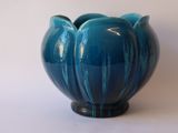 a blue vase that is sitting on a table