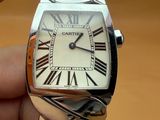 a person holding a wrist watch with roman numerals on it