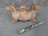 a figurine of a dog and a knife on a table