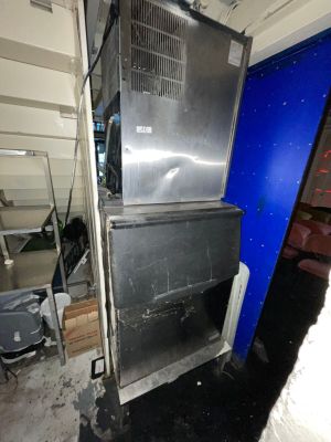 a large stainless steel refrigerator in a room with a blue wall