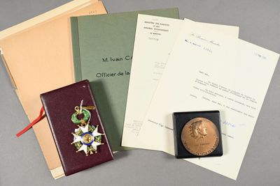 a book, a medal, and papers on a table