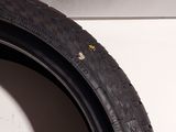 a close up of a tire on a white surface