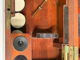 a small wooden box with a clock inside of it