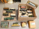 many toy trains in a box on the floor