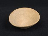 an image of a brown bowl sitting on top of a black table