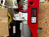a picture of a red and white electric winch and a box of tools